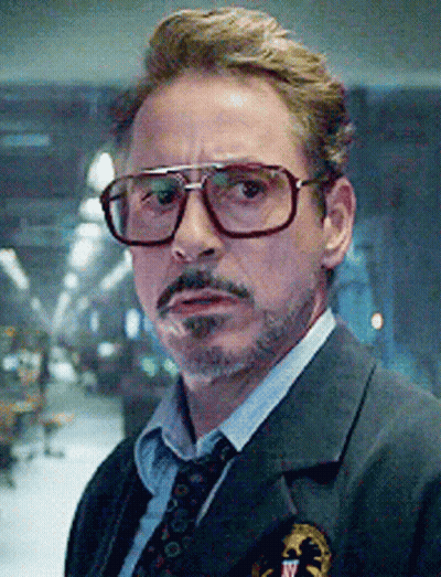 A Close Up Of A Man Wearing Glasses And A Suit And Tie . GIF