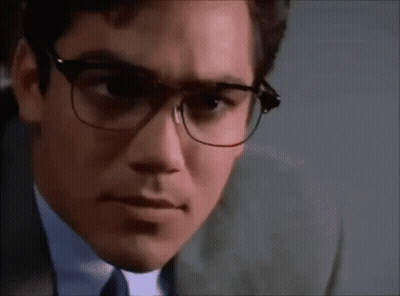 A Close Up Of A Man Wearing Glasses And A Suit And Tie . GIF