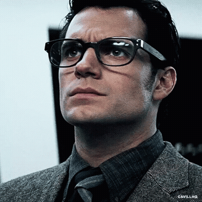 A Close Up Of A Man Wearing Glasses And A Suit And Tie . GIF