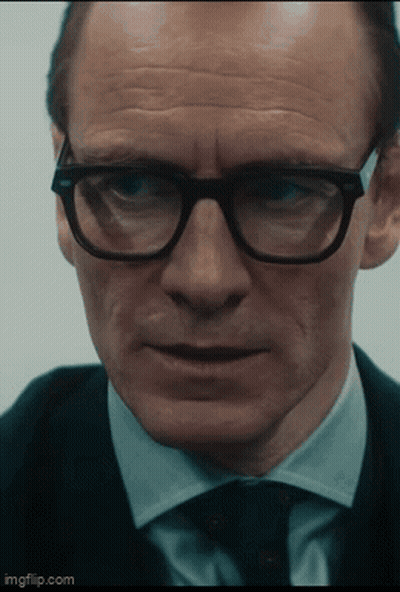 A Close Up Of A Man Wearing Glasses And A Suit With Imgflip.com At The Bottom GIF