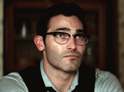 A Close Up Of A Man Wearing Glasses And A Tie GIF