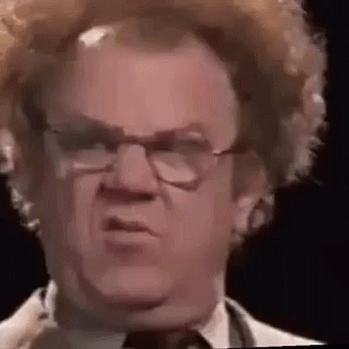 A Close Up Of A Man Wearing Glasses And A Wig . GIF