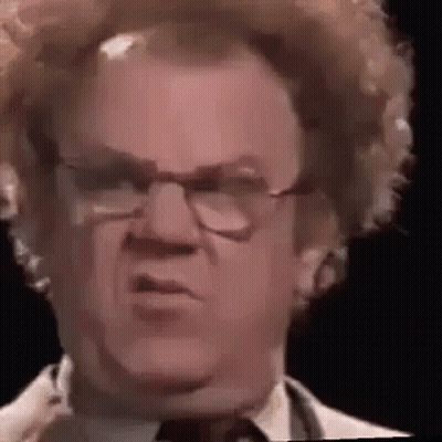 A Close Up Of A Man Wearing Glasses And A Wig . GIF