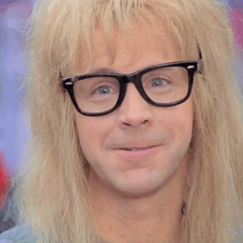 A Close Up Of A Man Wearing Glasses And A Wig GIF
