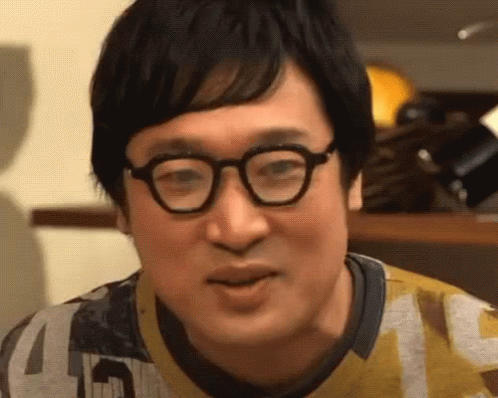 A Close Up Of A Man Wearing Glasses And A Yellow Shirt . GIF