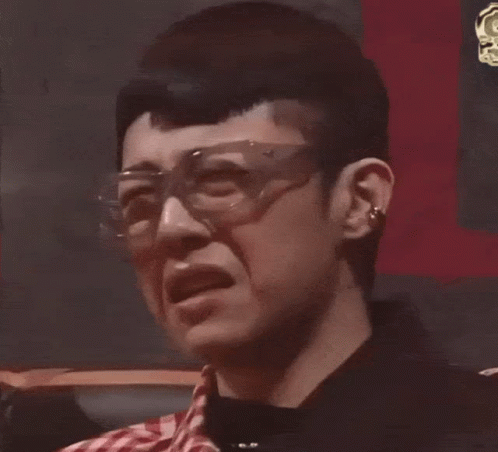 A Close Up Of A Man Wearing Glasses And Making A Funny Face GIF