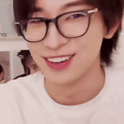 A Close Up Of A Man Wearing Glasses And Smiling . GIF