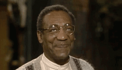 A Close Up Of A Man Wearing Glasses And Smiling . GIF