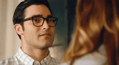 A Close Up Of A Man Wearing Glasses Looking At A Woman . GIF