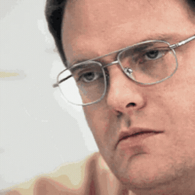 A Close Up Of A Man Wearing Glasses Looking At Something GIF
