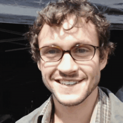 A Close Up Of A Man Wearing Glasses Smiling GIF