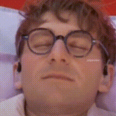 A Close Up Of A Man Wearing Glasses With His Eyes Closed . GIF
