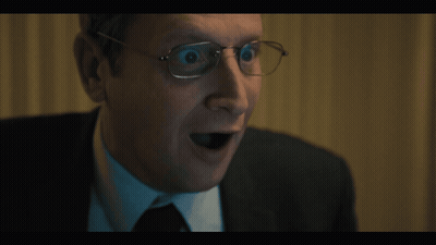 A Close Up Of A Man Wearing Glasses With His Mouth Open GIF