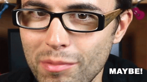 A Close Up Of A Man Wearing Glasses With The Word Maybe On The Bottom Right GIF
