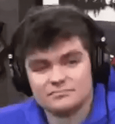 A Close Up Of A Man Wearing Headphones And Making A Funny Face . GIF
