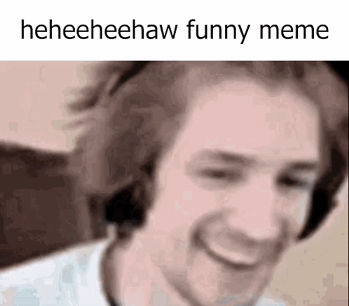 A Close Up Of A Man Wearing Headphones And Smiling With The Words Heeheehaw Funny Meme Written Above Him . GIF