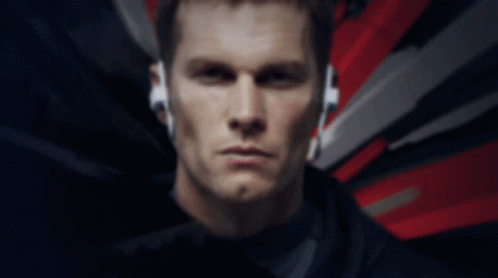 A Close Up Of A Man Wearing Headphones With A Red And White Background GIF