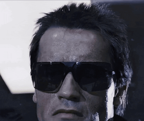 A Close Up Of A Man Wearing Sunglasses And A Black Jacket GIF