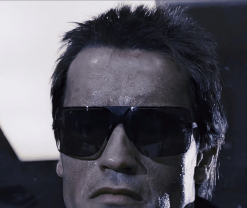 A Close Up Of A Man Wearing Sunglasses And A Black Jacket GIF