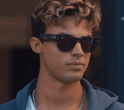 A Close Up Of A Man Wearing Sunglasses And A Blue Hoodie GIF