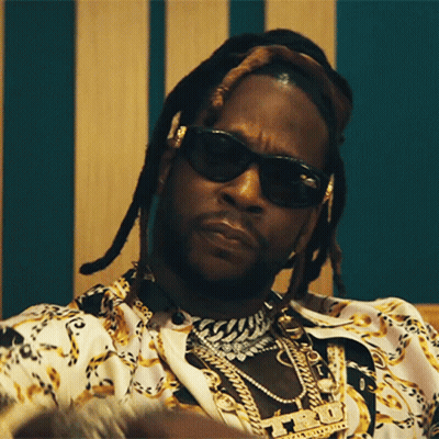 A Close Up Of A Man Wearing Sunglasses And A Necklace With A Pendant That Says ' T.i. ' GIF