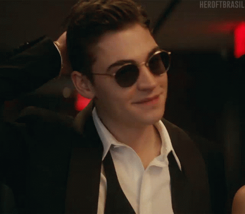 A Close Up Of A Man Wearing Sunglasses And A Suit And Tie . GIF