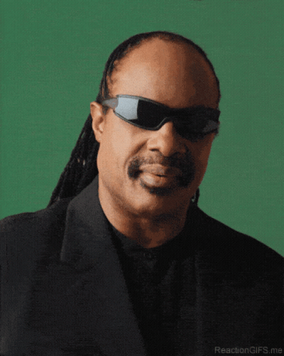 A Close Up Of A Man Wearing Sunglasses And A Suit GIF