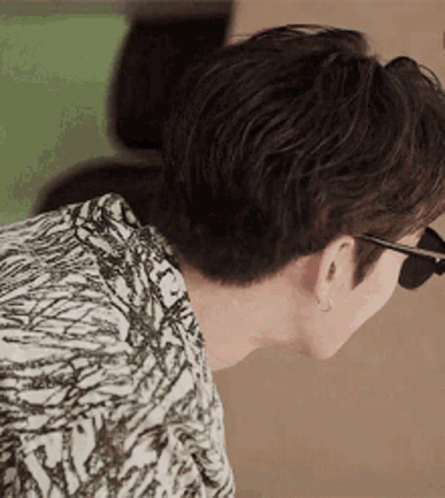 A Close Up Of A Man Wearing Sunglasses And A Zebra Print Shirt . GIF