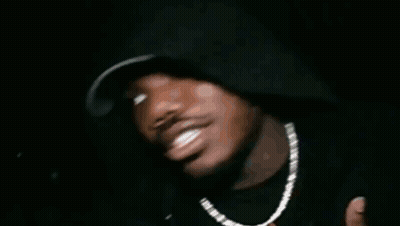 A Close Up Of A Man Wearing Sunglasses And Earrings GIF