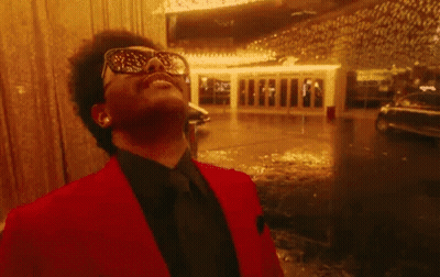 A Close Up Of A Man Wearing Sunglasses And Laughing With His Mouth Open . GIF