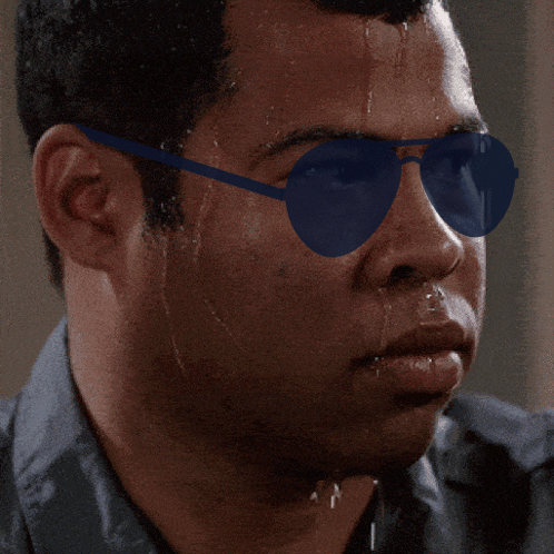 A Close Up Of A Man Wearing Sunglasses With Sweat Coming Out Of His Face GIF