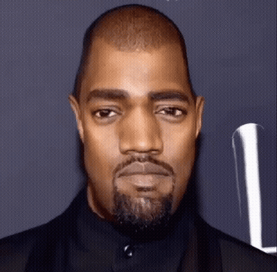 A Close Up Of A Man With A Beard And A Black Suit . GIF
