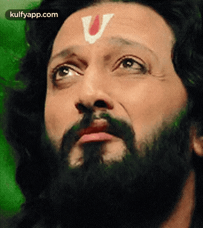 A Close Up Of A Man With A Beard And A V On His Forehead . GIF