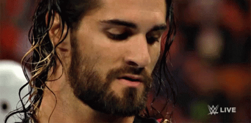 A Close Up Of A Man With A Beard And A W Live Logo GIF
