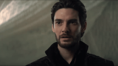 A Close Up Of A Man With A Beard And Black Hair GIF