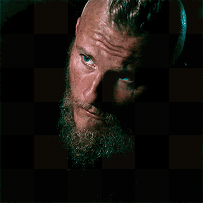 A Close Up Of A Man With A Beard And Blue Eyes Looking At The Camera . GIF
