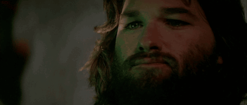 A Close Up Of A Man With A Beard And Long Hair GIF
