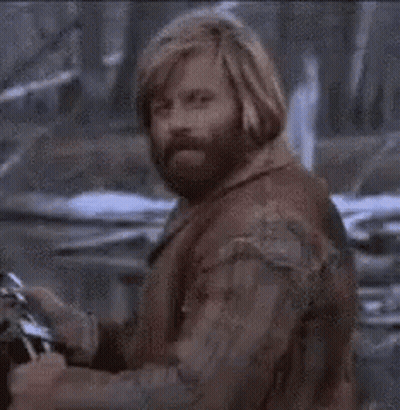 A Close Up Of A Man With A Beard And Long Hair . GIF