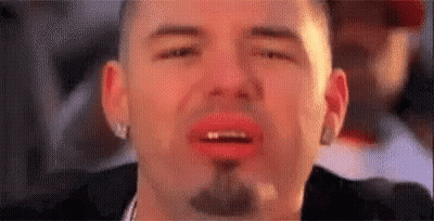 A Close Up Of A Man With A Beard And Red Lips Crying . GIF