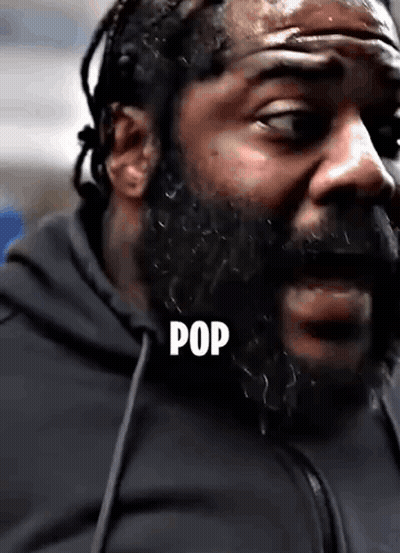 A Close Up Of A Man With A Beard And The Word Pop Written On His Face . GIF