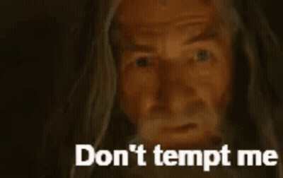 A Close Up Of A Man With A Beard And The Words `` Do N't Tempt Me '' Written On The Bottom . GIF