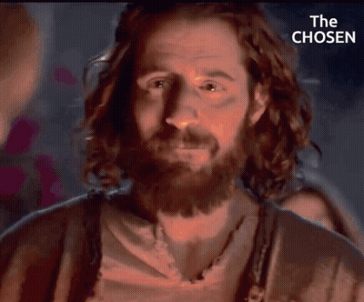 A Close Up Of A Man With A Beard And The Words " The Chosen " Behind Him GIF