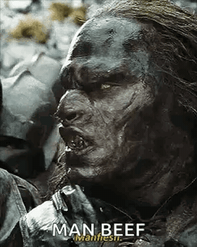 A Close Up Of A Man With A Beard Eating Man Beef . GIF