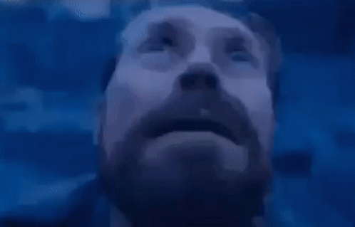 A Close Up Of A Man With A Beard Looking Up At The Sky . GIF