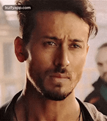 A Close Up Of A Man With A Beard Making A Sad Face . GIF