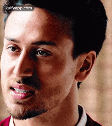 A Close Up Of A Man With A Beard Smiling . GIF