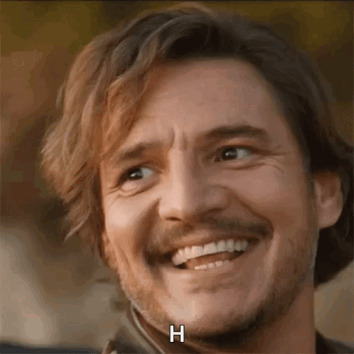 A Close Up Of A Man With A Beard Smiling With The Letter H Written On His Face . GIF