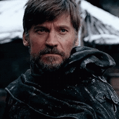 A Close Up Of A Man With A Beard Wearing A Black Coat GIF
