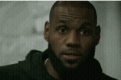 A Close Up Of A Man With A Beard Wearing A Black Hoodie GIF