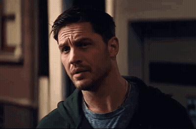 A Close Up Of A Man With A Beard Wearing A Green Hoodie And A Grey T-Shirt . GIF